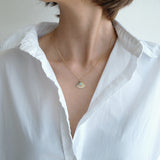 Necklace styled in a minimalist outfit to highlight natural stone