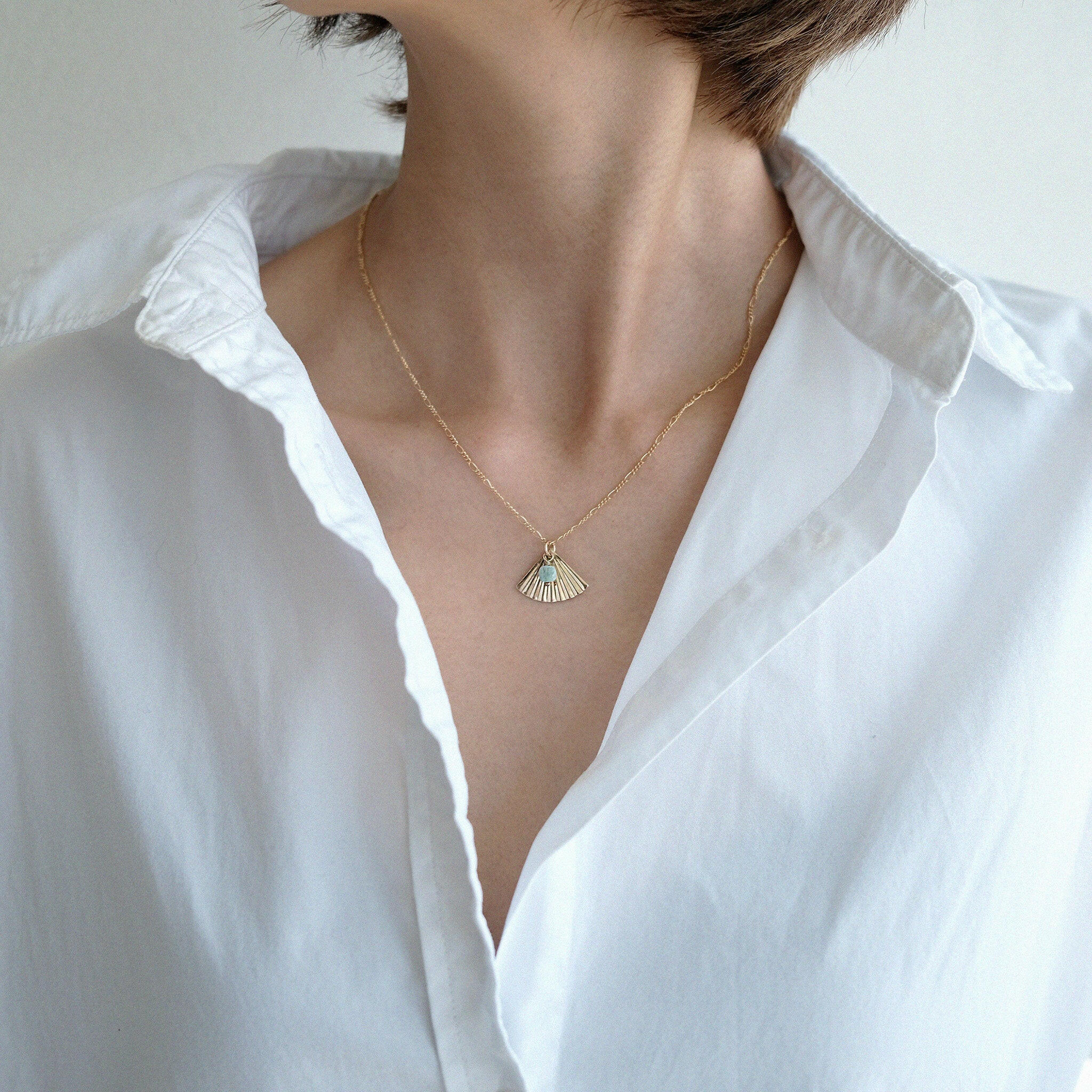 Necklace styled in a minimalist outfit to highlight natural stone