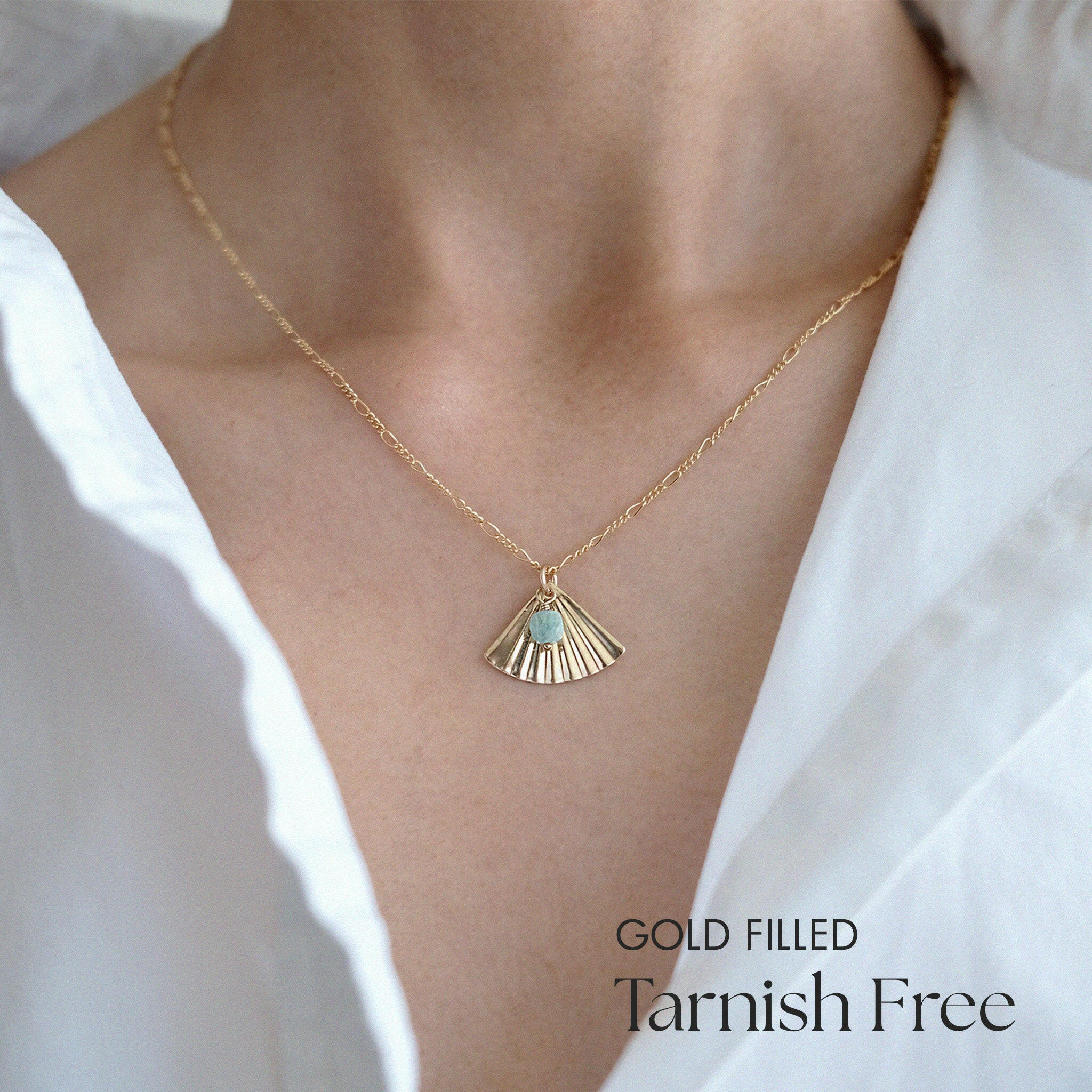 Model wearing Cardia necklace as a solo accent with light blouse