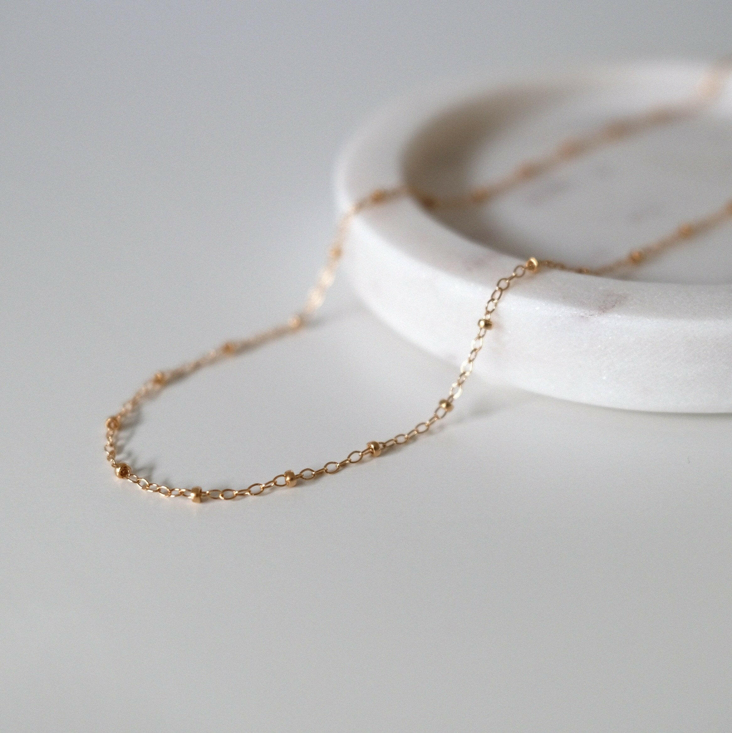 Close-up of gold filled chain showing dainty bead accents