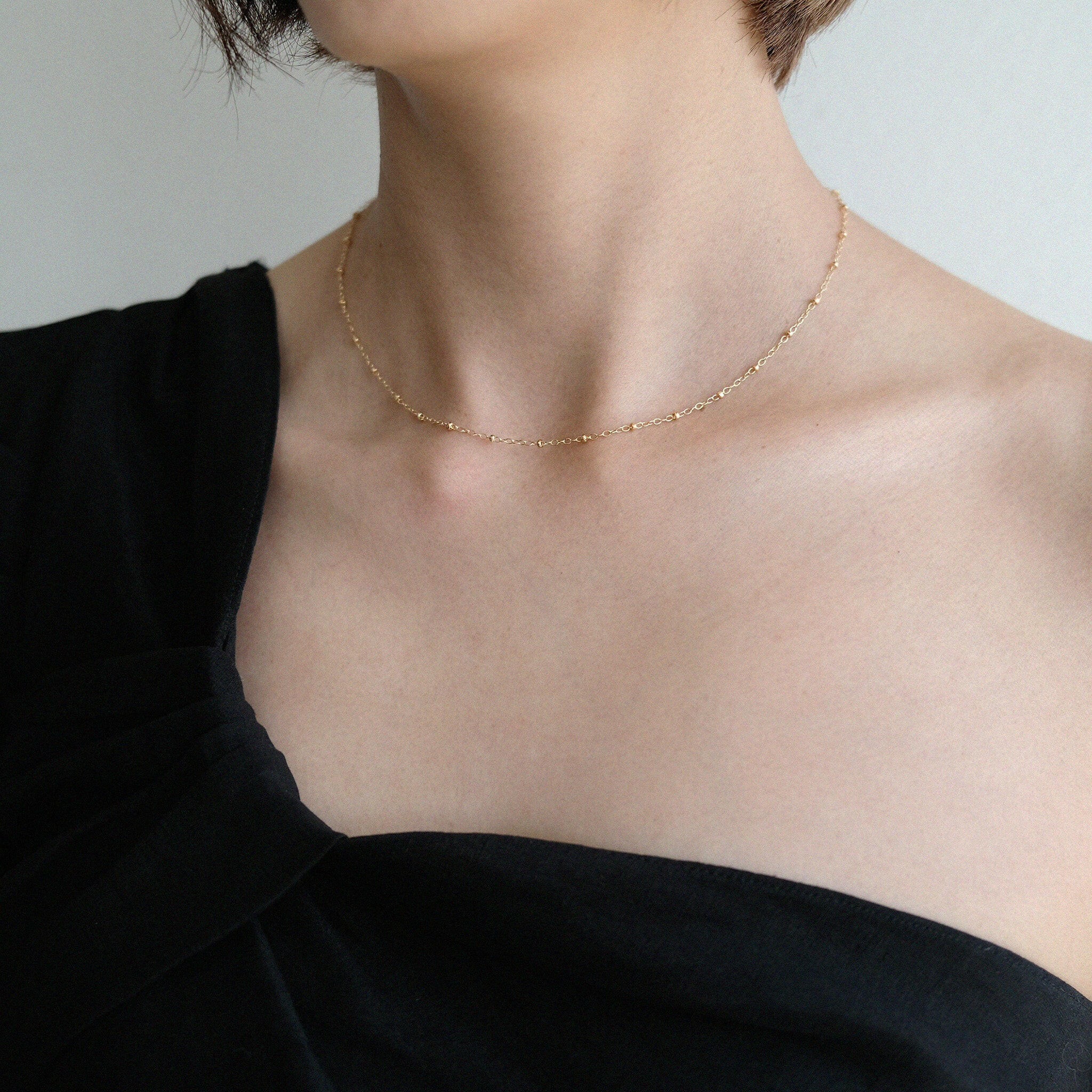 Model wearing beaded chain alone