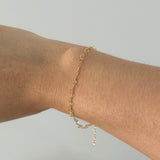 Bracelet worn on wrist viewed from above, showcasing linked hearts and slim profile