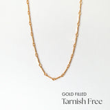 Close-up of alternating gold filled links in clean layout
