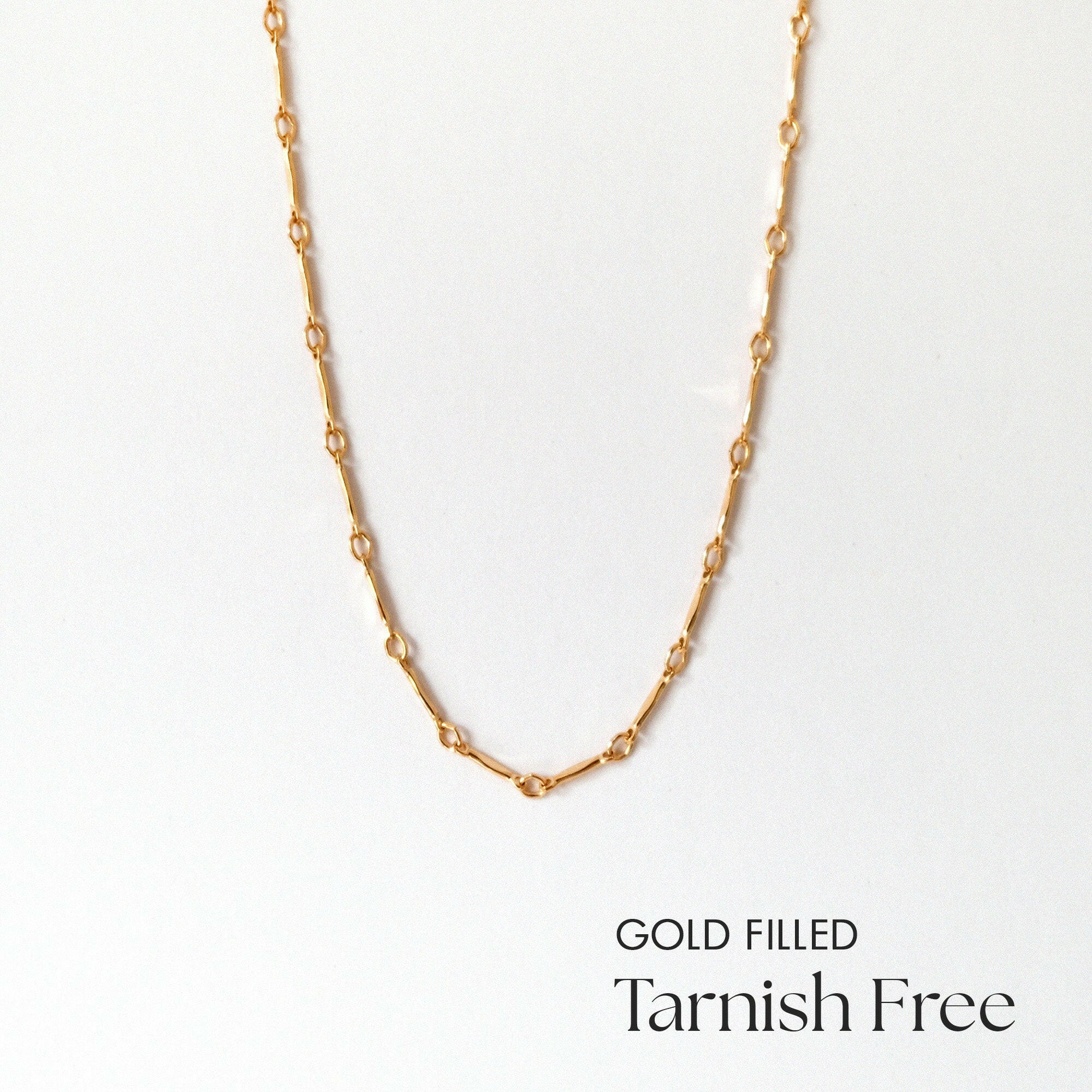 Close-up of alternating gold filled links in clean layout
