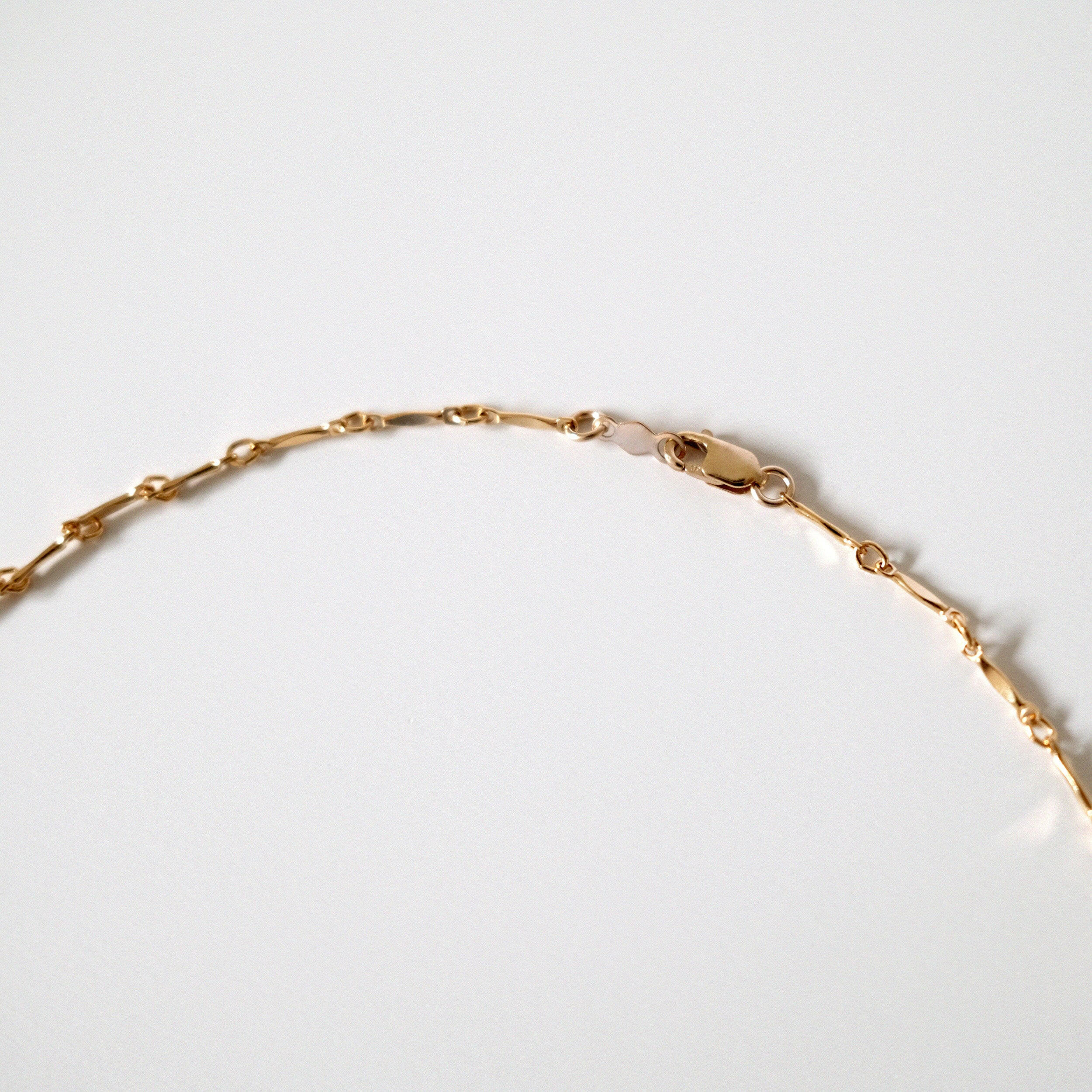 Close-up of polished gold links reflecting soft light