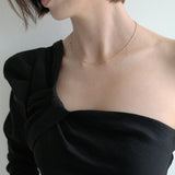 Model wearing Lydia necklace solo with a minimalist styling