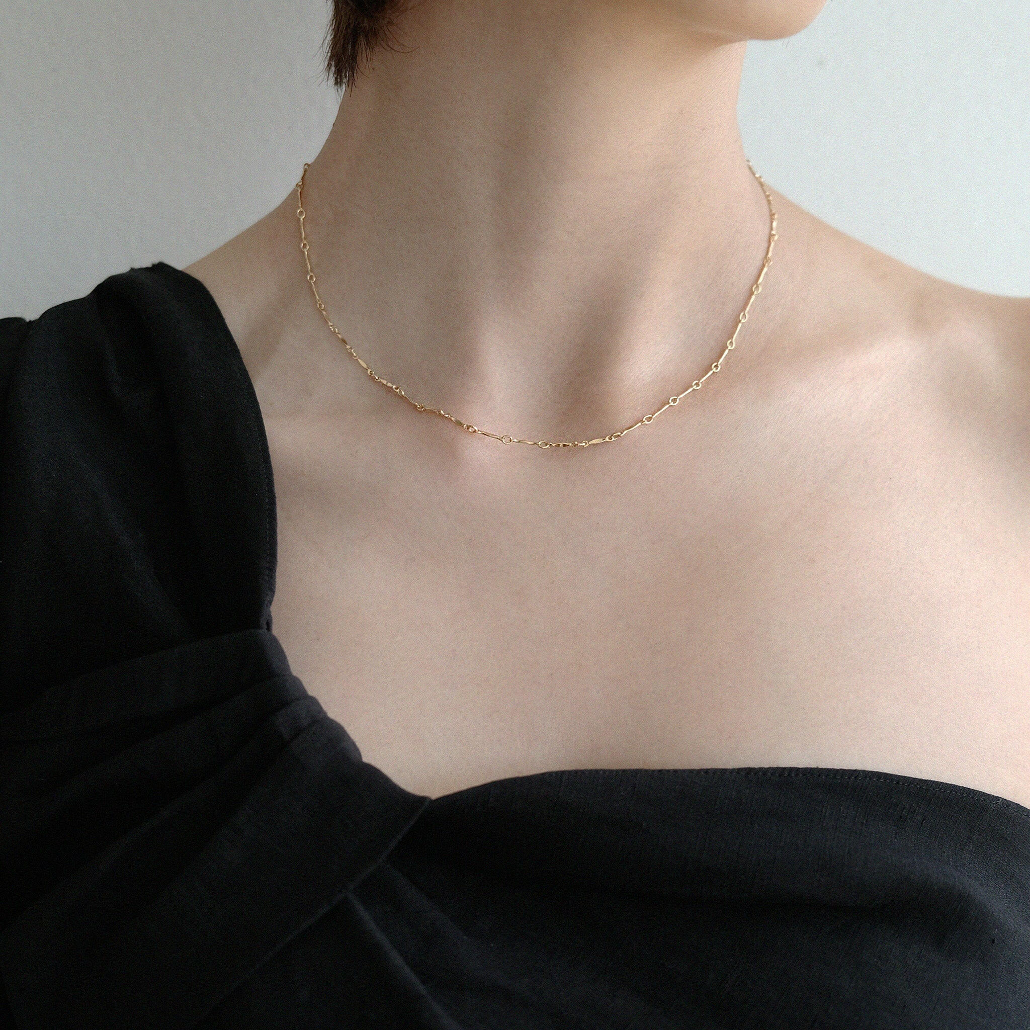 Model wearing Lydia necklace solo with a minimalist neckline