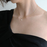 Model wearing Syros necklace as solo