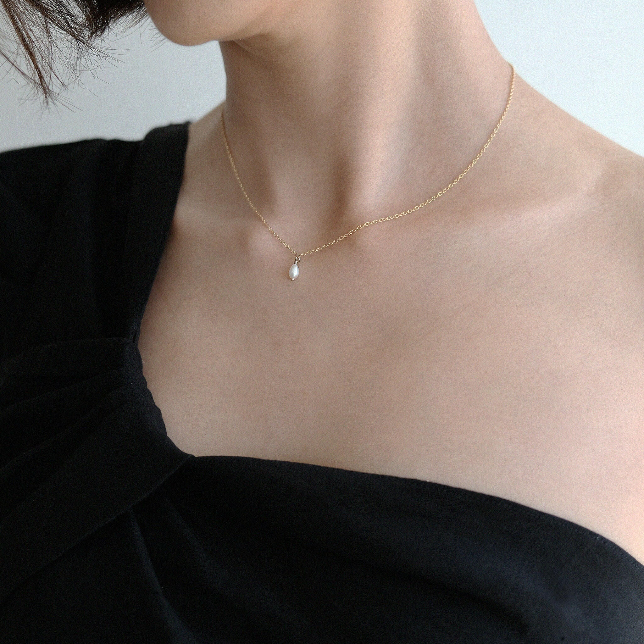 Model wearing Syros necklace as solo