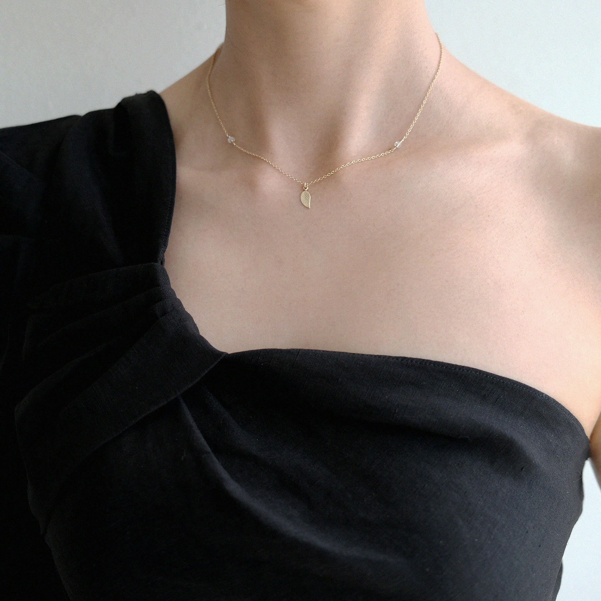 Model wearing nature-inspired necklace