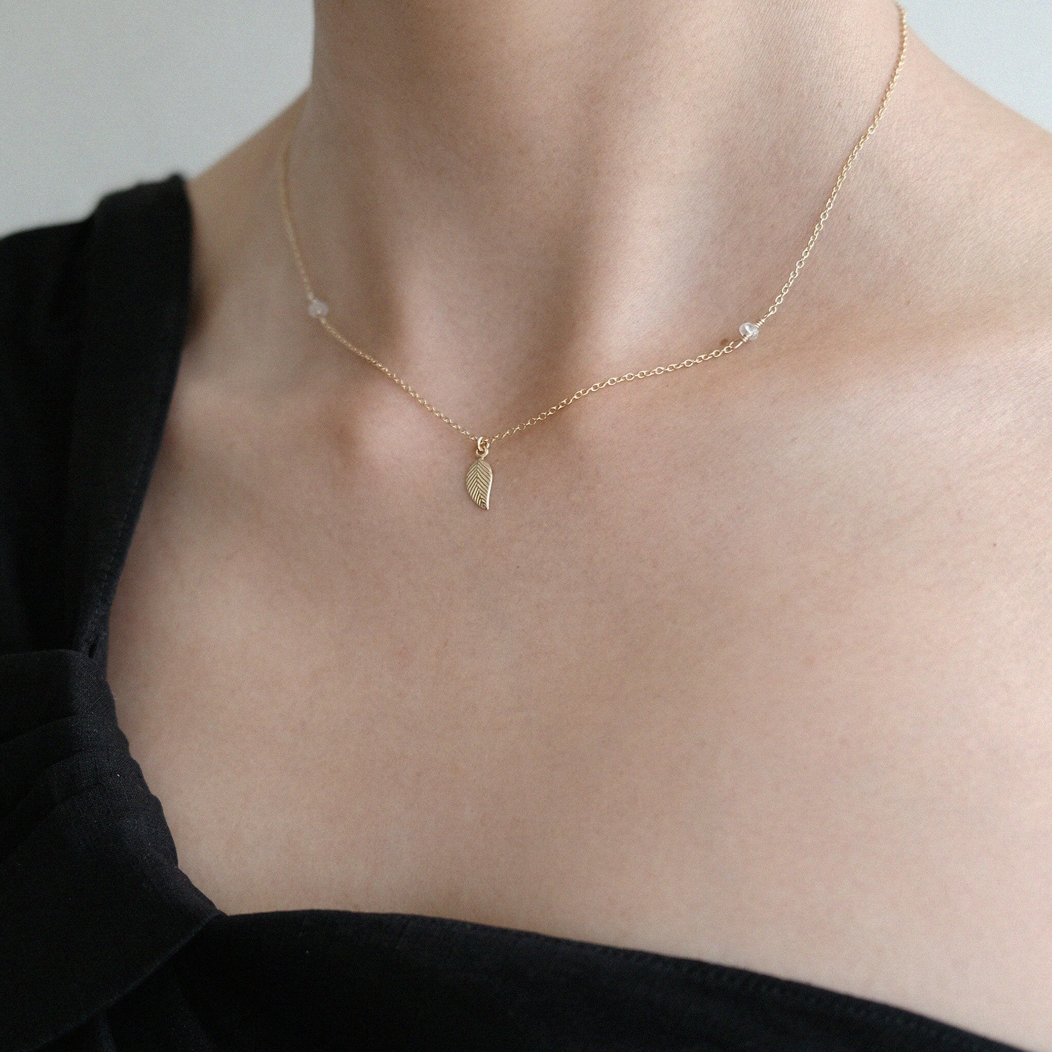 Model wearing nature-inspired necklace as part of an everyday outfit