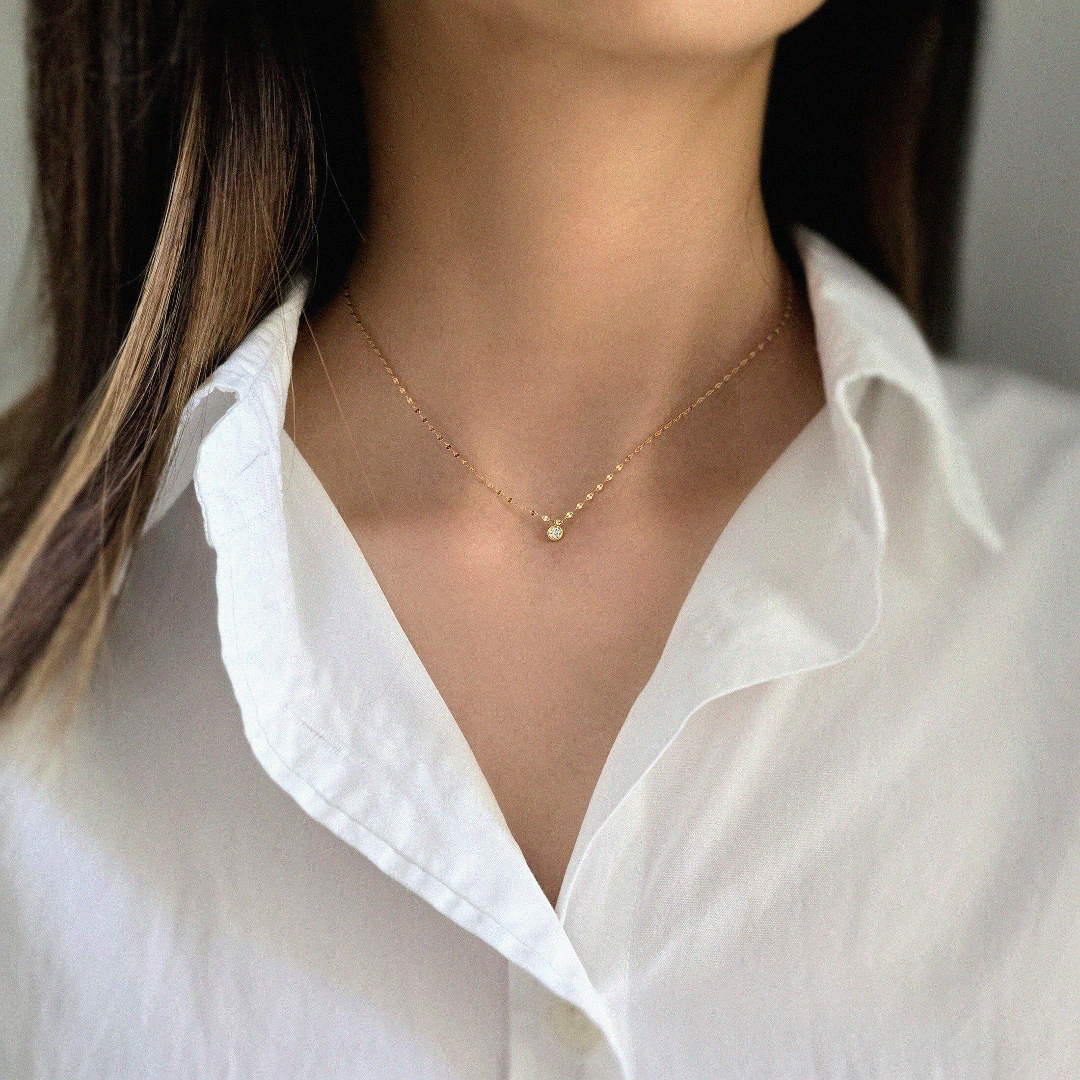 Close-up of cubic zirconia pendant shining subtly against the skin