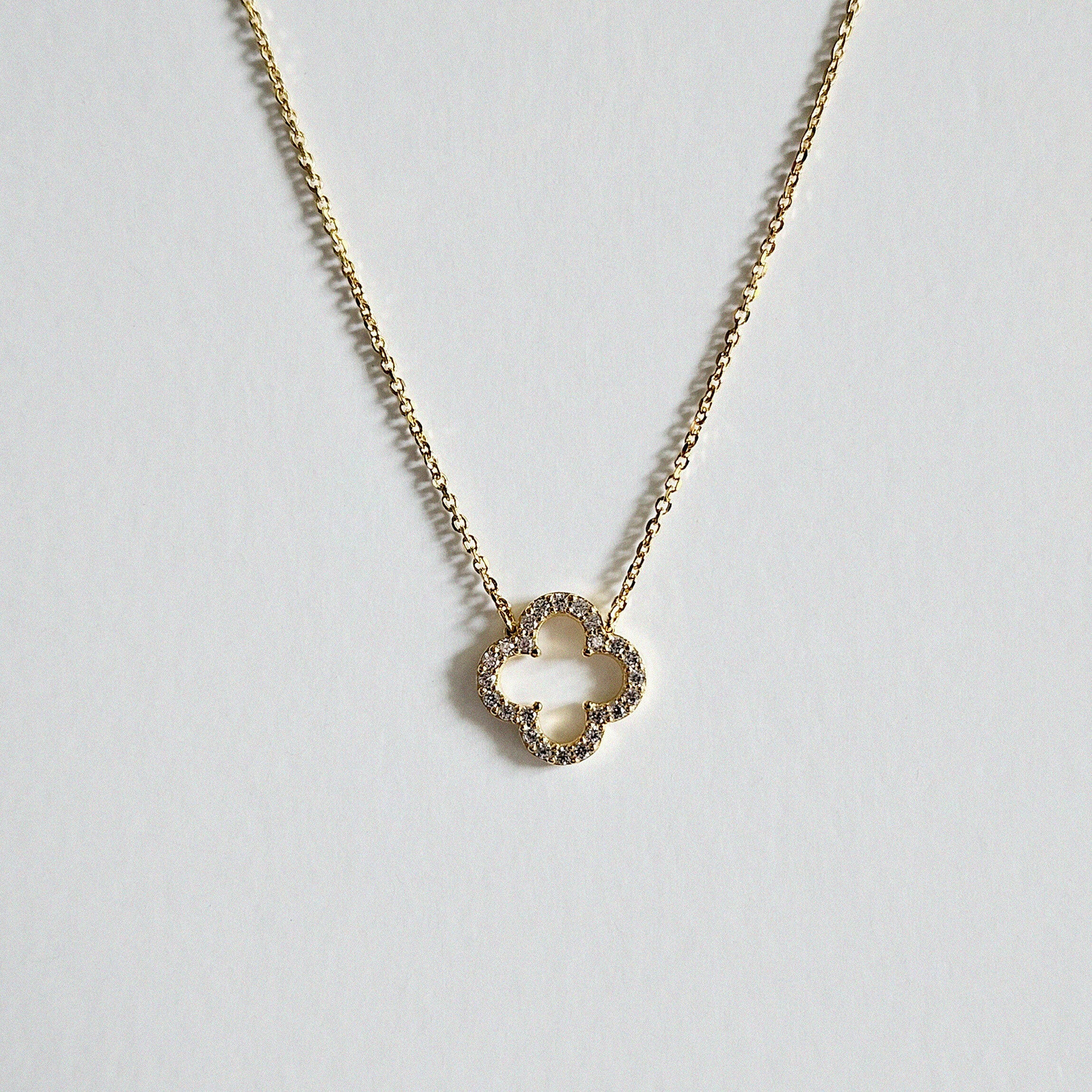 Macro shot of cubic zirconia clover charm showing faceted crystal details