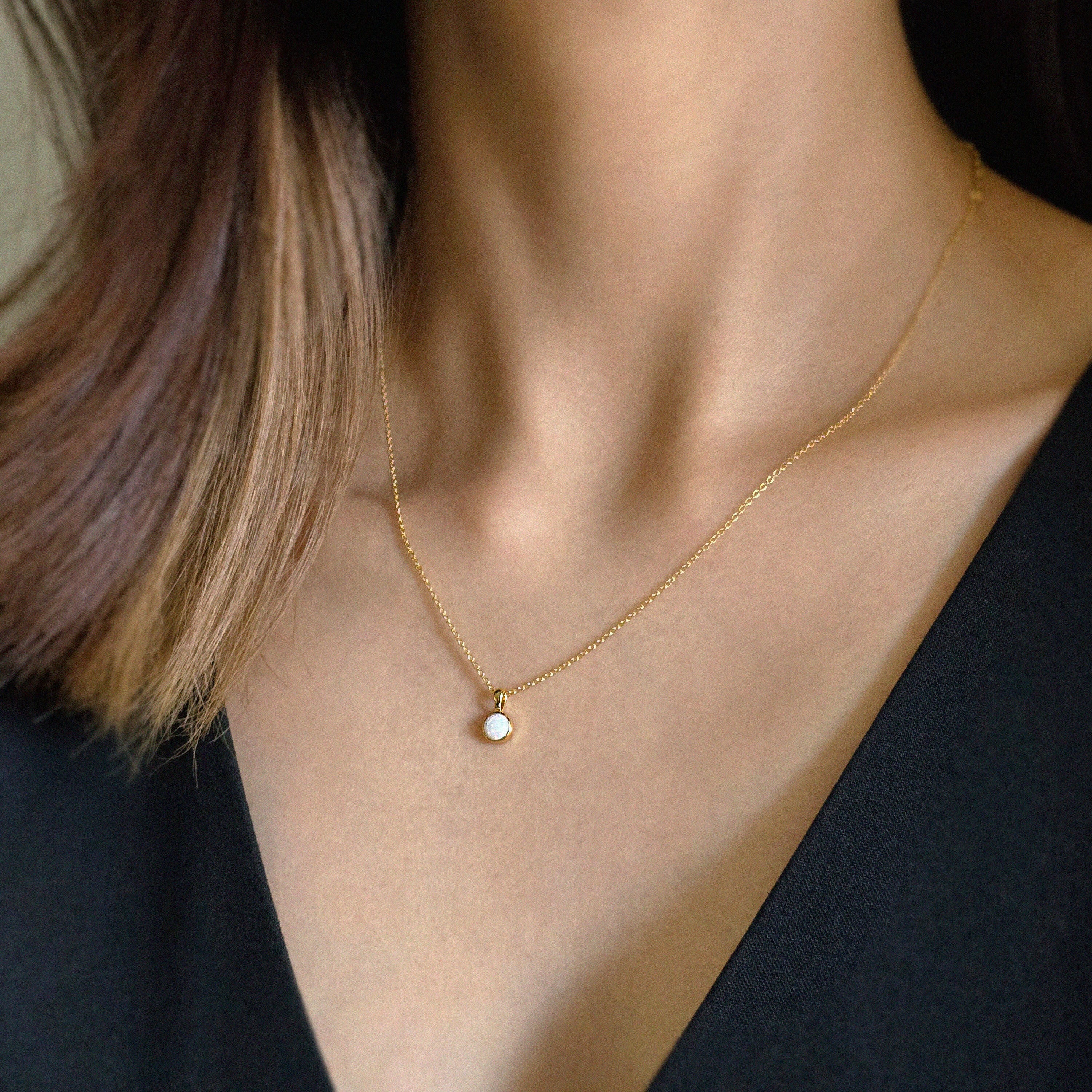 White opal version styled alone against the neckline