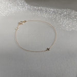 Delicate gold bracelet showing its dainty links in natural movement