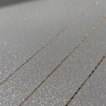 Minimalist bracelets shimmering with movement, highlighting geometric detail