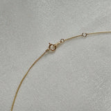 Close-up of spring ring clasp on 14K gold necklace with O-ring extender
