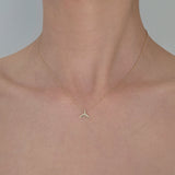 Whale tail pendant resting near collarbone on model – ocean-inspired elegance