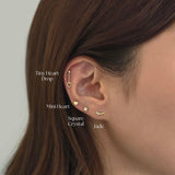Jade Cartilage Earring stacked with multiple gold studs and cartilage in curated ear styling