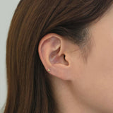 14K gold trio ball earring worn in low helix piercing