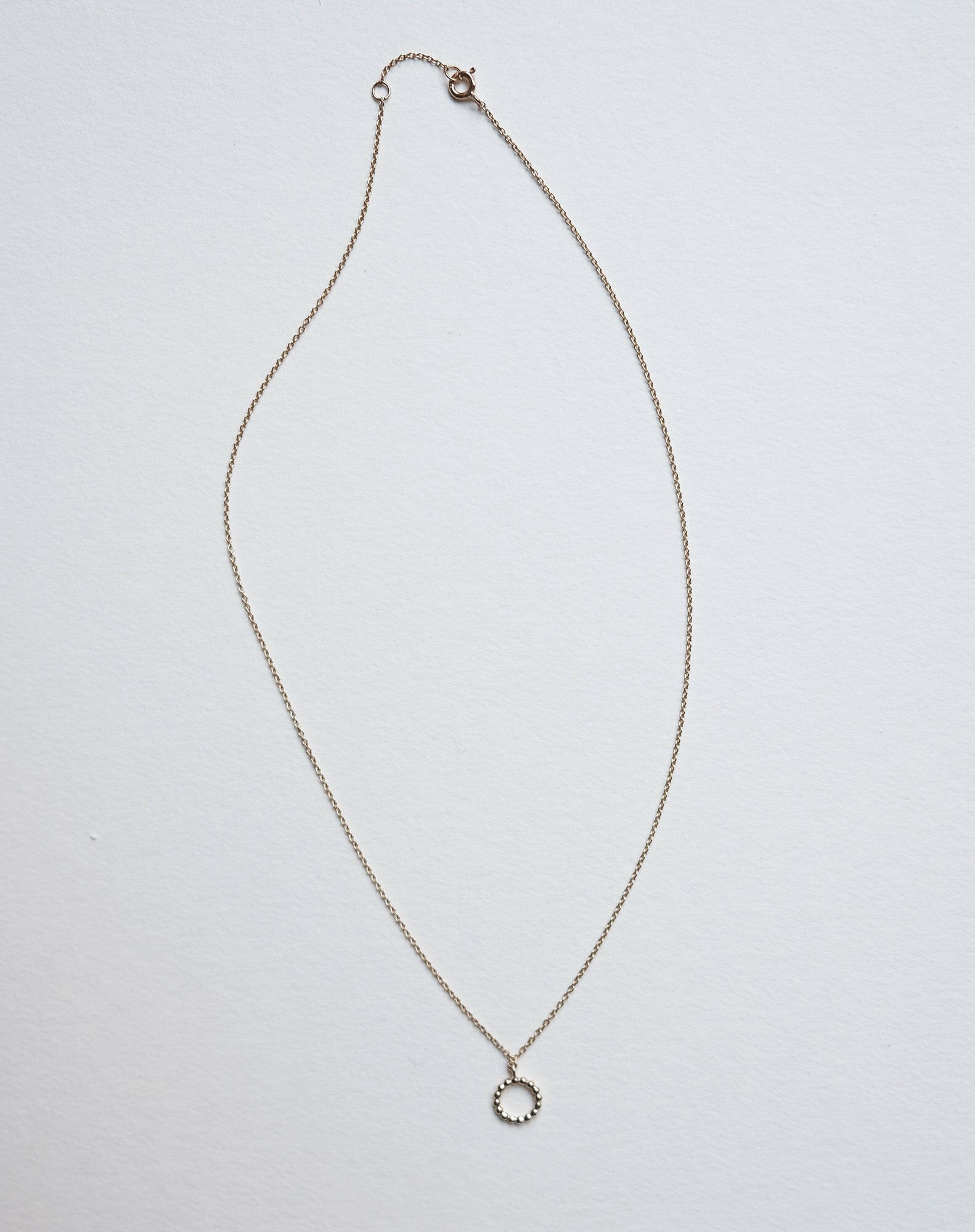 Calla Necklace laid flat in full length to display chain structure and balance
