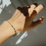 Model wearing Aria Bracelet from above, showing subtle green and gold detail