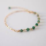Close-up of natural aventurine stones with polished gold filled chain