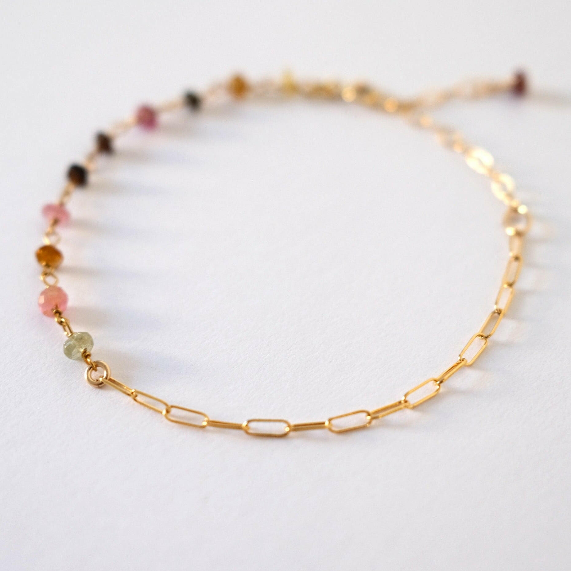 Close-up of tourmaline beads and gold links