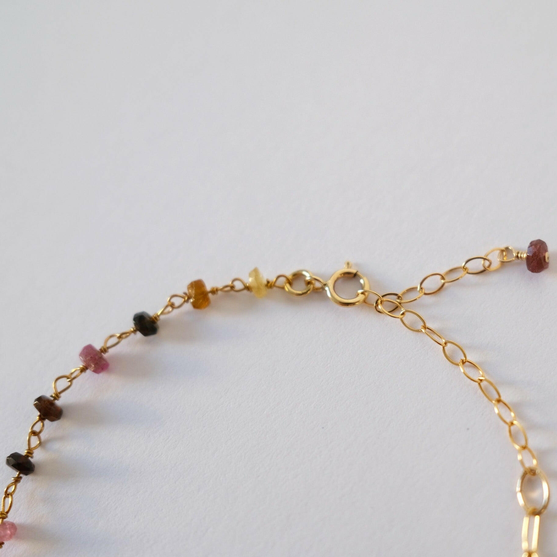 Detail of lobster clasp and final gemstone beads in focus