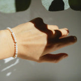 Mari Pearl Bracelet styled solo on wrist with dainty pearls and gold beads