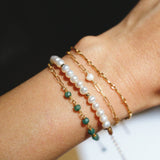 Model wrist featuring Mari Bracelet with delicate layering stack