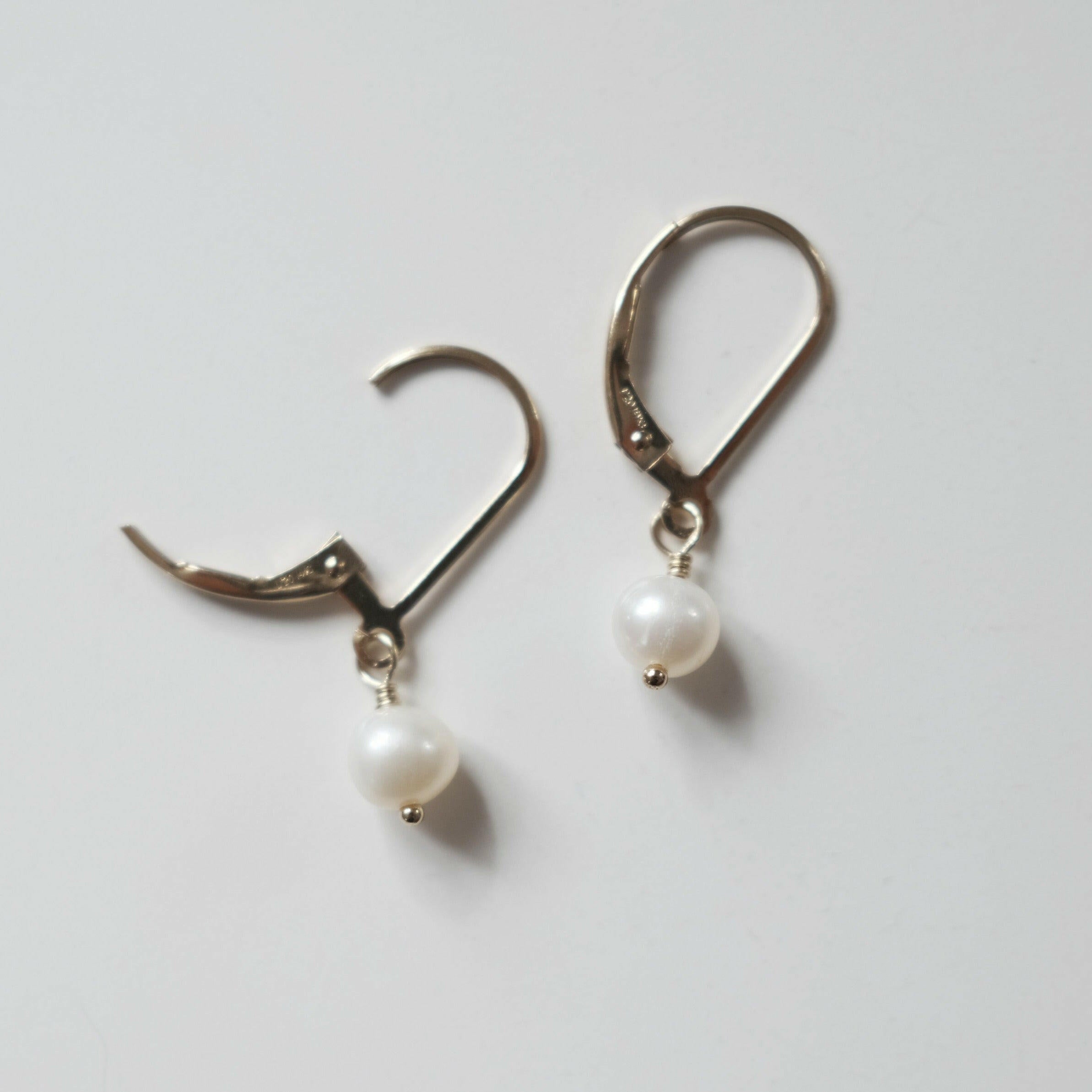 Close-up of Olivia Pearl Earring showing two of large pearl and smooth finish