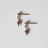 Petite gold drop earrings with small round ruby gemstones and gold posts
