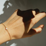 Wrist view from above showing bold links and pearl in middle