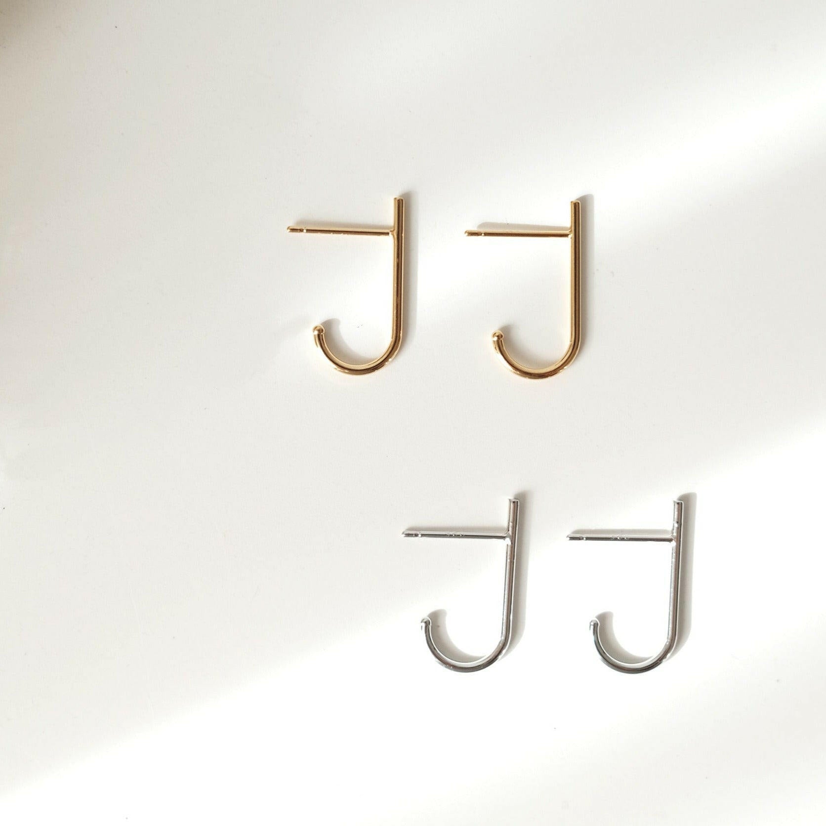 Minimal chic earrings featuring sleek J shaped line for a modern design enhancing elegance and style.
