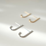 Minimal chic earrings featuring sleek J shaped line for a modern design enhancing elegance and style.