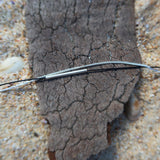 Elegant anklet featuring thread chain and silver bar accent, perfect jewelry piece for a stylish casual look.