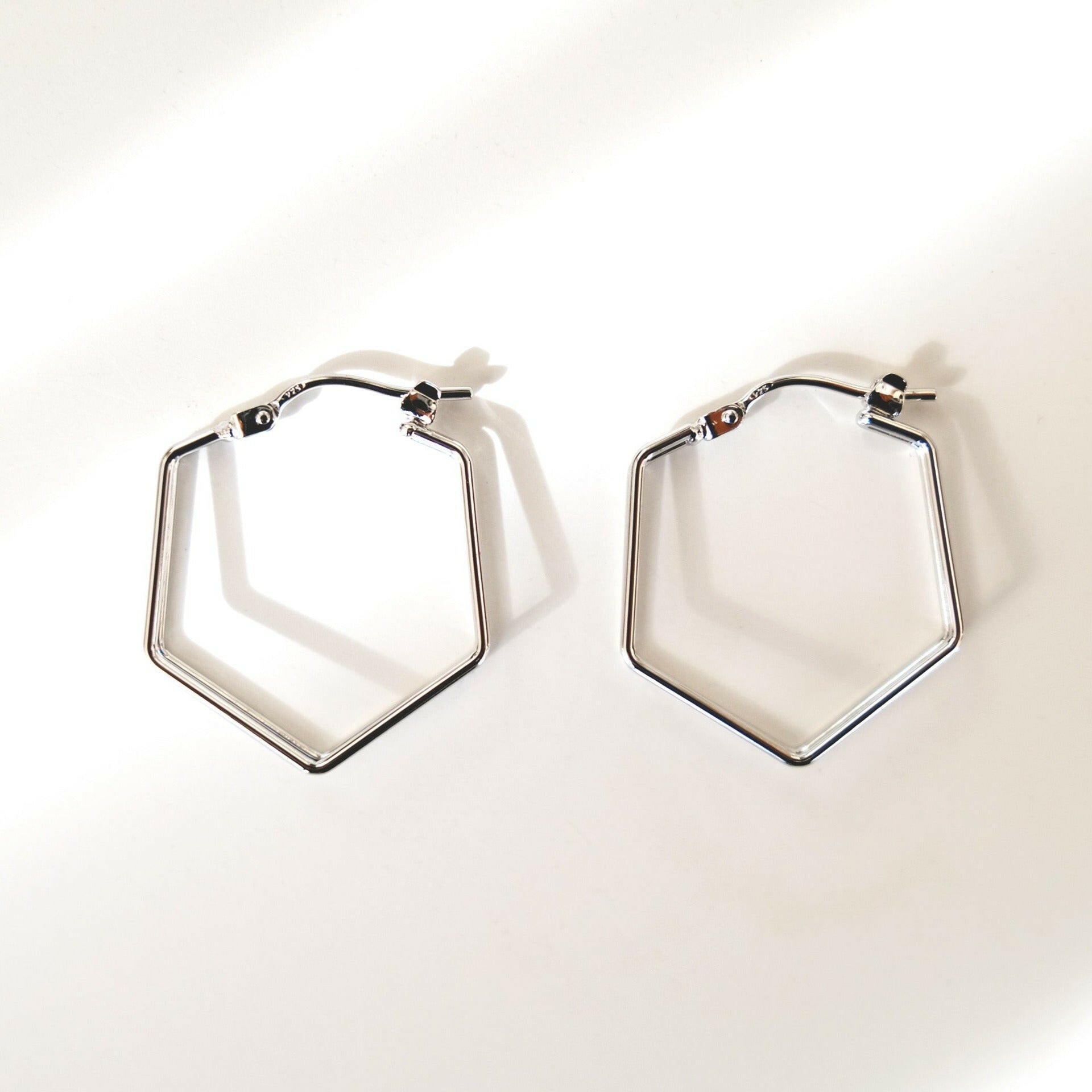 Modern chic hexagon dual lined hoops with simple elegant design, perfect for minimalist style and contemporary fashion.