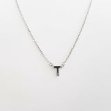 Necklace with a letter 'T' pendant on a white background