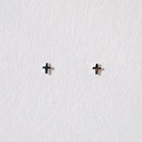 Tiny cross studs in sterling silver featuring minimal symbolism and a sleek design for elegant style