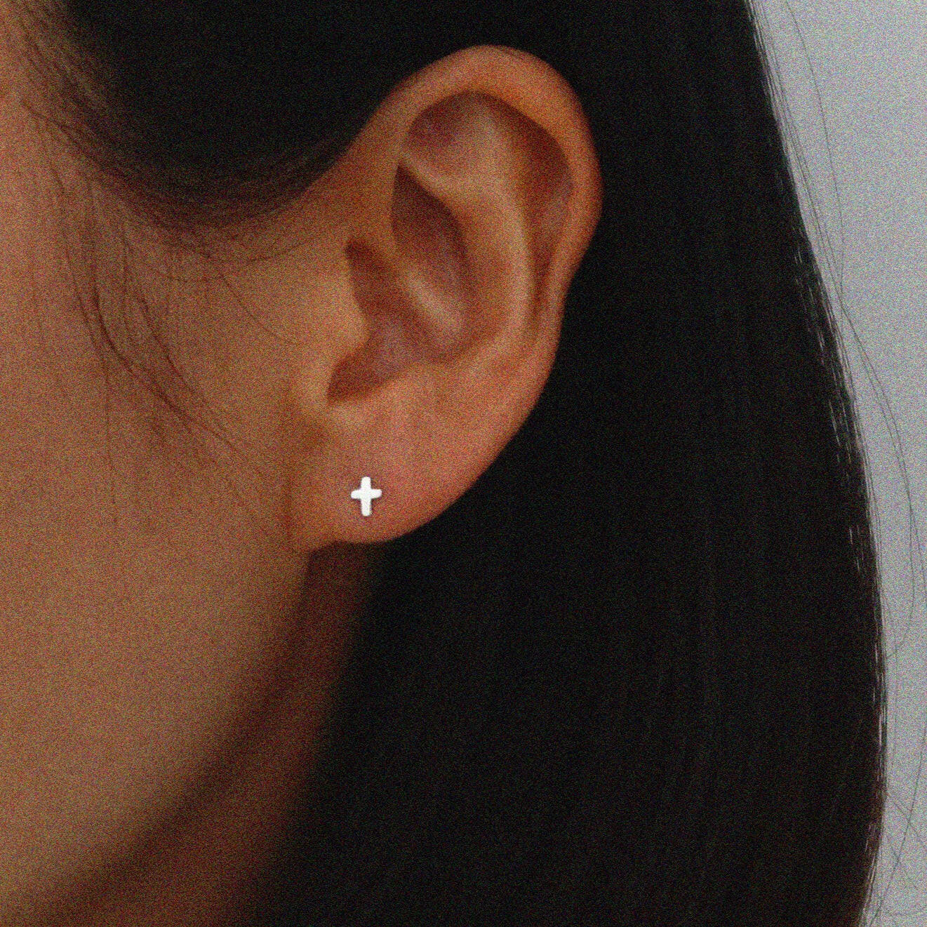 Tiny cross studs in sterling silver featuring minimal symbolism and a sleek design for elegant style
