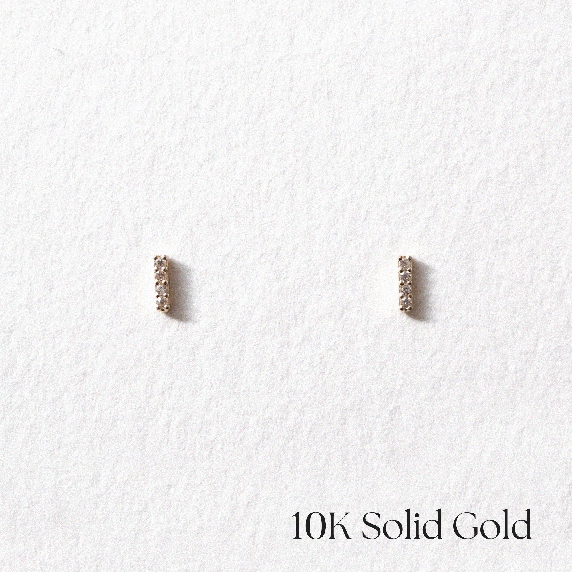 Front view of 10K Petite CZ Line Studs with slim gold bar design