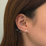Model showcasing 2mm, 3mm and 4mm crystal studs layered in elegant ear stack