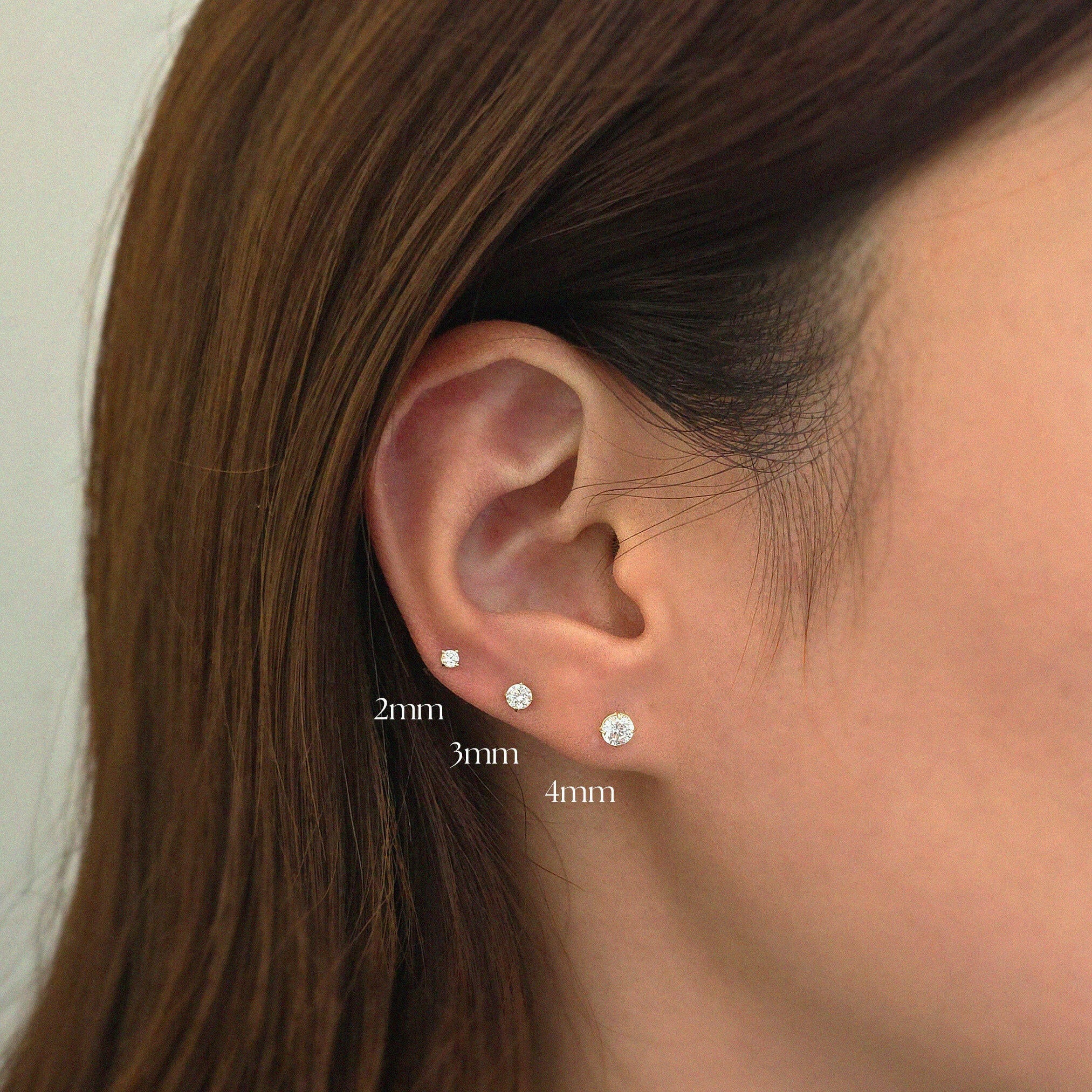 Model showcasing 2mm, 3mm and 4mm crystal studs layered in elegant ear stack