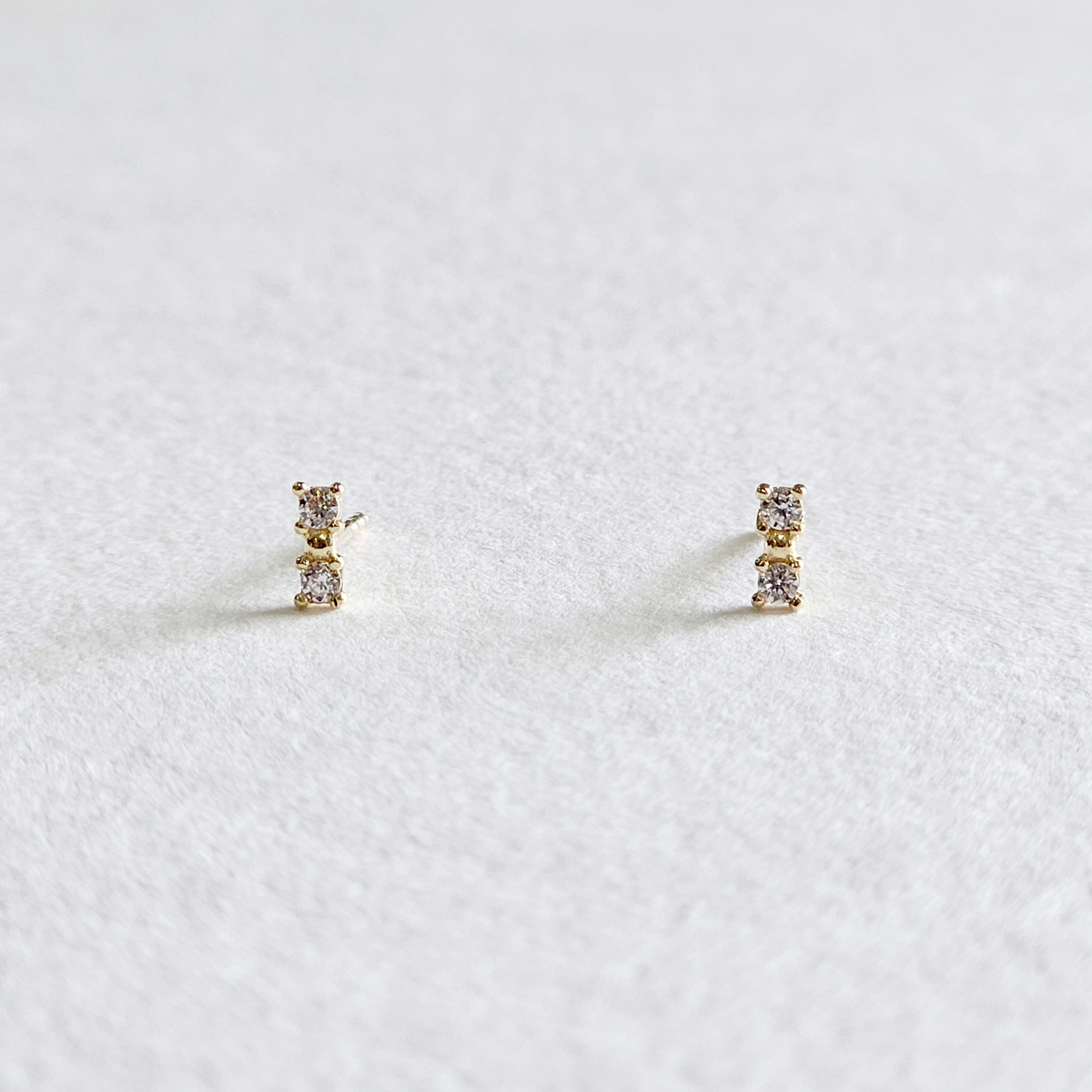Front view of BonBon earrings in 14K gold with rectangular cubic zirconia detail