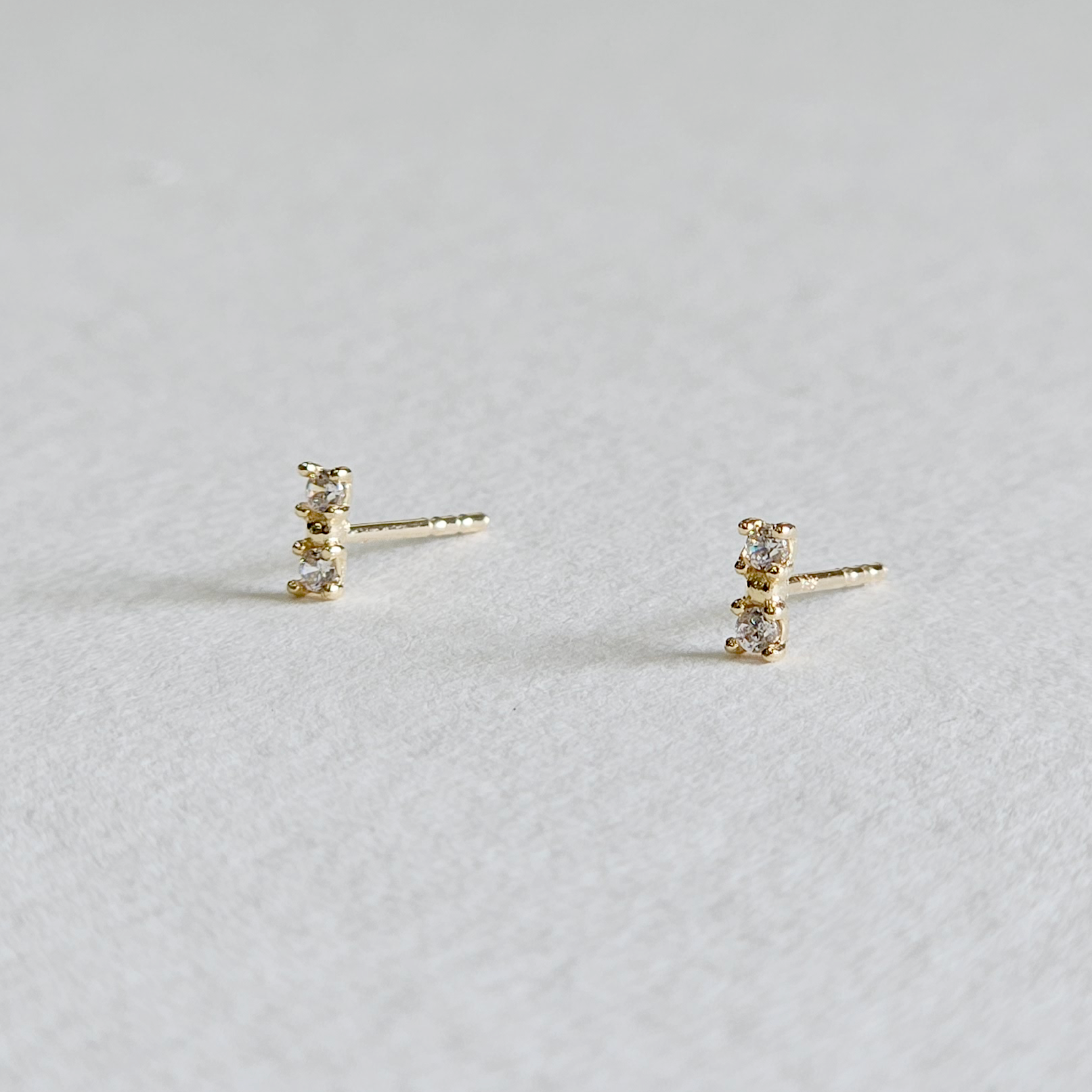 Side profile of BonBon earrings showing narrow design and shine