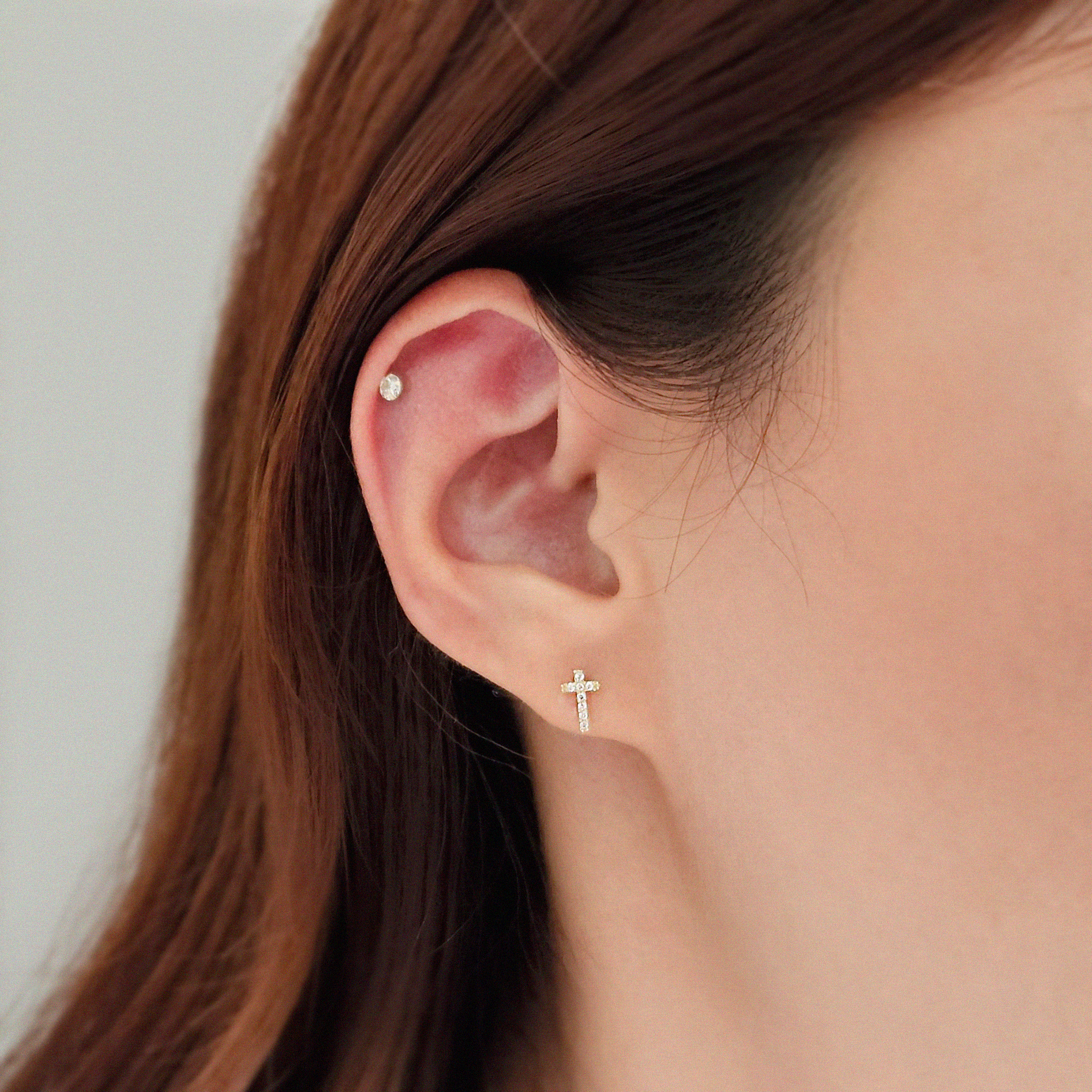 Model wearing Crystal Cross studs for minimal faith-inspired look