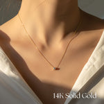 14K Solid Gold necklace on a person wearing a white shirt.