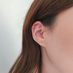 Model wearing Flower Trio earrings for elegant vertical accent"