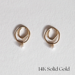 Front view of 14K Little Pond Earrings with flowing gold form and freshwater pearl